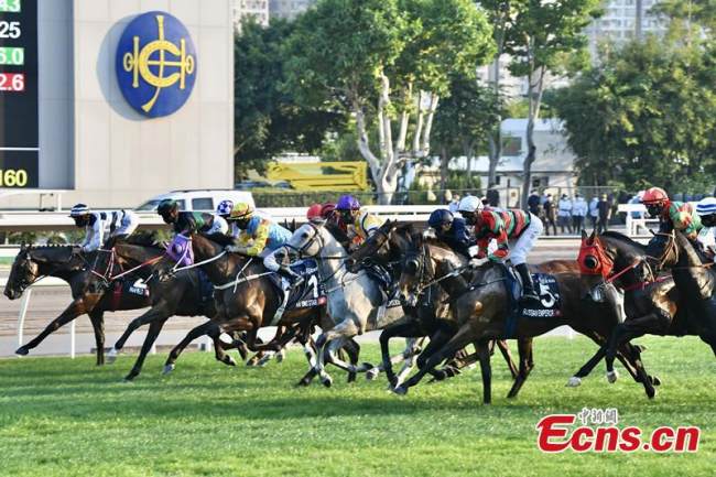 Τα άλογα ιπποδρομιών τρέχουν σε σκληρό ανταγωνισμό για τη γραμμή τερματισμού στον ιππόδρομο Sha Tin στην Ειδική Διοικητική Περιοχή του Χονγκ Κονγκ, 12 Δεκεμβρίου 2021. (φωτογραφία / China News Service)