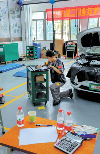 Η Γκου Χουιτζίνγκ ενώ εργάζεται στην συντήρηση οχημάτων στο Σεντζέν της επαρχίας Γκουανγκντόνγκ. (Φωτογραφία CHINA DAILY )