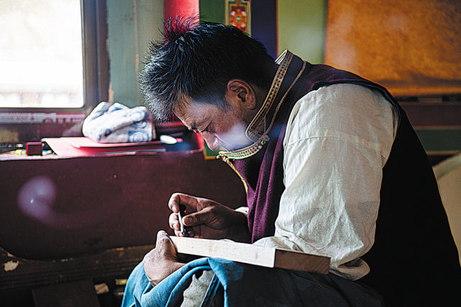 Ο Κάρμα Τσόντρακ εργάζεται στο εργαστήριό του. [Φωτογραφία/Xinhua]