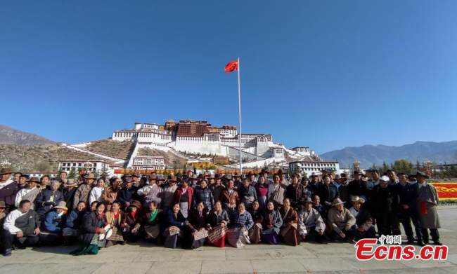 Άνθρωποι ποζάρουν για μια ομαδική φωτογραφία μετά από μια τελετή για τον εορτασμό της Ημέρας Χειραφέτησης των Δουλοπάροικων στην πλατεία μπροστά από το Παλάτι Ποτάλα στη Λάσα, πρωτεύουσα της Αυτόνομης Περιοχής του Θιβέτ στην νοτιοδυτική Κίνα, στις 28 Μαρτίου 2022. (Φωτογραφία: China News Service)