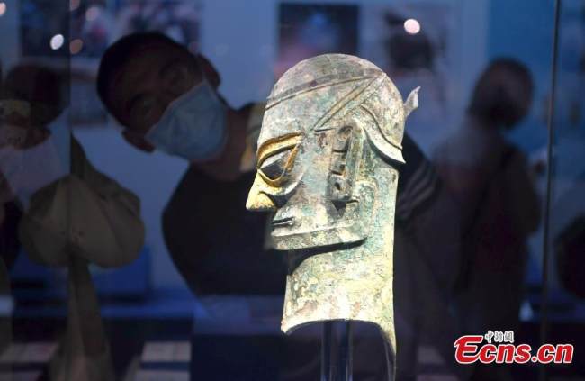 Ένα χάλκινο ανθρώπινο κεφάλι που φοράει χρυσή μάσκα εκτίθεται στο Μουσείο Φουτζιέν, της πόλης Φουτζόου, στην επαρχία Φουτζιέν στην νοτιοανατολική Κίνα, στις 12 Μαΐου 2022. (Φωτογραφία: China News Service)