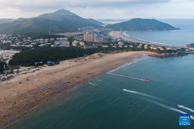 Αεροφωτογραφία που τραβήχτηκε στις 2 Αυγούστου 2022 δείχνει τουρίστες να απολαμβάνουν τον ελεύθερο χρόνο τους δίπλα στη θάλασσα στο γραφικό σημείο Τζουτζιατζιέν του Τζοουσάν, στην επαρχία Τζετζιάνγκ, της ανατολικής Κίνας.